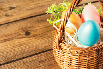 Basket of easter eggs on wooden table