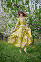 Obraz na płótnie Canvas beautiful woman in dress in the gardens
