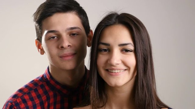 Young  teenage boy and girl start smiling, while doing an Eskimo kiss