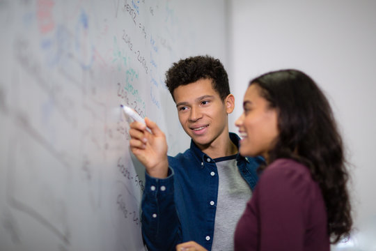 Students at a whiteboard with pen