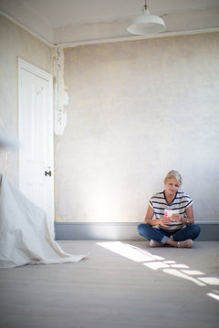 Mature female choosing paint colors