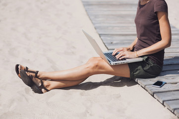Young woman using laptop computer outdoors