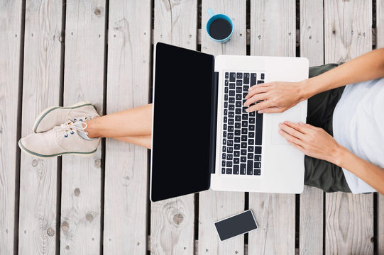 Young Woman Using Laptop Computer Outdoors