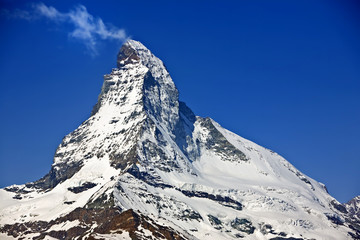 Vapor smoke trail off the Matterhorn. Hiking in the mountains above Zermatt