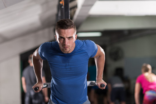 man doing exercises parallel bars