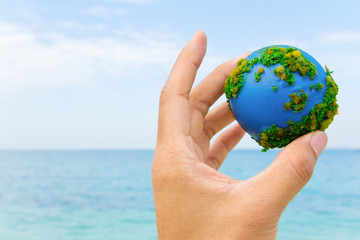 Earth in hand, hand holding world icon with nature , environment friendly concept