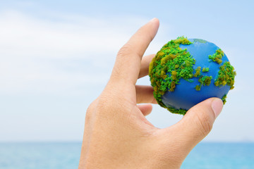 Earth in hand, hand holding world icon with nature , environment friendly concept