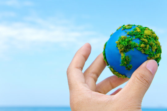 Earth in hand, hand holding world icon with nature , environment friendly concept