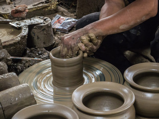 Master are molding clay to make earthenware