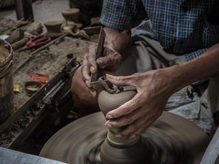 Master are molding clay to make earthenware