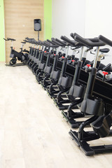 Fototapeta na wymiar Unterior of a fitness hall with sport bikes