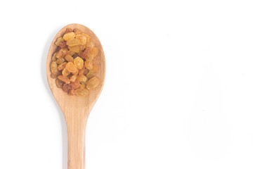 Raisins. Dried Grapes into a spoon