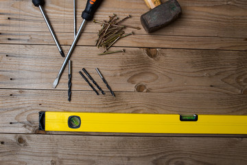 Overhead image of tools, ready for DIY project on a wooden background