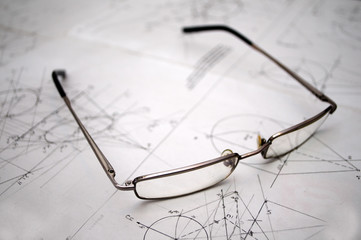 Student glasses left on plans for construction
