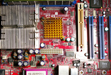 Close up of a computer motherboard and hard  drive.