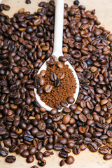 Iinstant coffee in spoon on coffee beans background