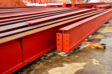 Rows of steel I beams ready for installation at nearby construction site.