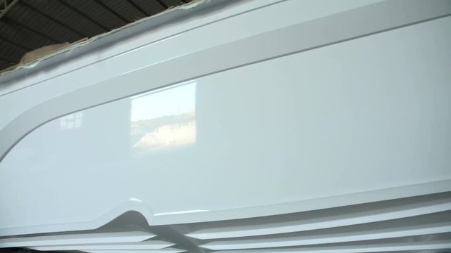 New shiny hull of a boat in construction in a shipyard.