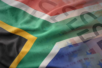 colorful waving national flag of south africa on a euro money banknotes background. finance concept