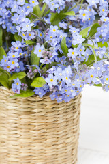 blue flowers bouquet on white wooden background