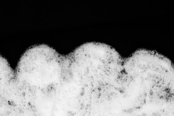 foam for shaving on a black background