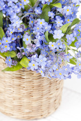 blue flowers bouquet on white wooden background