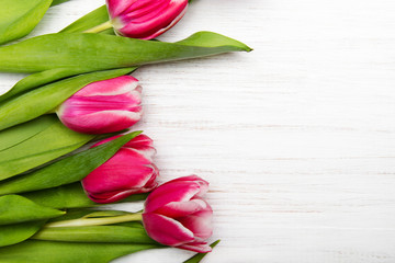 Tulip bouquet on white wooden background, copy space