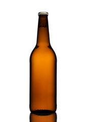 Brown glass beer bottle with yellow cap on white