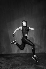Fototapeta na wymiar Young beautiful fitness female posing in studio