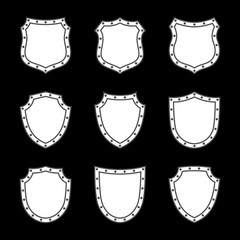 Shield shape icons set. White label signs isolated on black background. Symbol of protection, arms, security, safety. Flat retro style design. Element vintage heraldic emblem Vector illustration