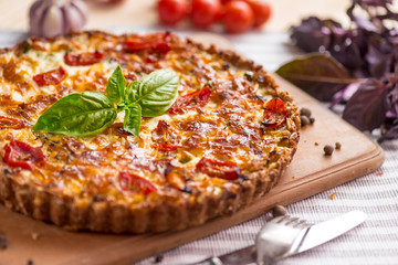 Vegetable open cake with tomatoes and green basil