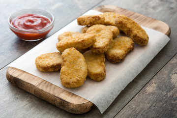 Fried chicken nuggets on wooden table
