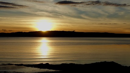 Sunset over dark Scottish island