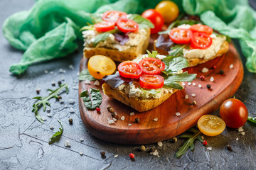 Two fresh sandwiches with cherry tomatoes