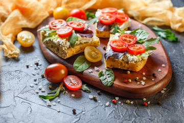 Two fresh sandwiches with cherry tomatoes