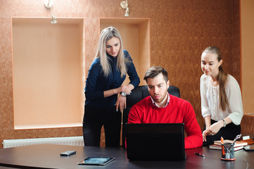 Businesspeople using laptop at conference table