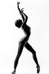 Young beautiful ballerina posing in studio