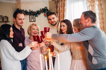 large family celebrates Christmas and drinking champagne