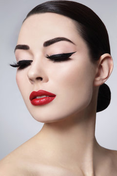 Glamorous Portrait Of Young Beautiful Woman With Black Eyeliner And Red Lips