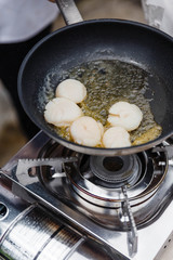 Chef Fried Scallops with Rosemary Oil in Pan with Spoon.