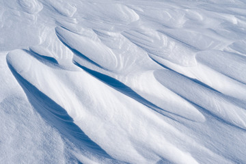 Whimsical beautiful shapes of weathered snow surface 