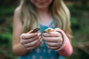 Girl holding reptiles