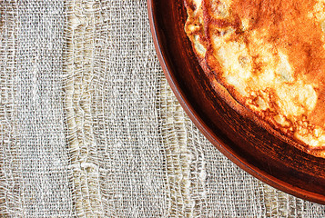Maslenitsa, traditional Russian pancakes -  blini on a plate of dark clay.