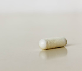 Fototapeta na wymiar Medicine white capsules on white backgraund.