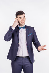 businessman gesturing with his finger against temple asking are you crazy? emotions, facial expressions, feelings, body language, signs. image on a white background.