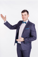 man presenting or showing something your text or product. human emotion expression and lifestyle concept. image on a white studio background.
