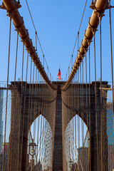 Obraz premium Stars and stripes flying on Brooklyn Bridge