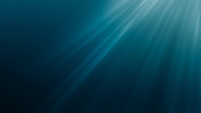 Sunlight rays shining through ocean surface. View from underwater. 3D rendered animation.