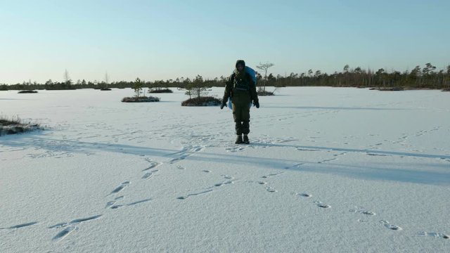 Young man dances on the frozen lake