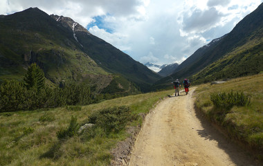 Two tourists on the mountain way